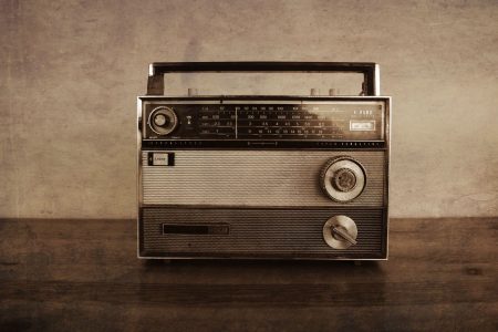 transistor-radio-vintage-1960s-on-a-wood-table-PEYLSJ7